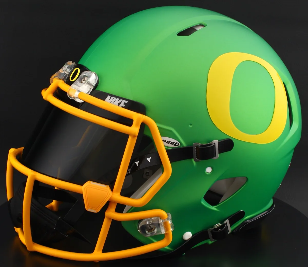 Oregon Ducks Riddell Replica Speed Football Helmet – Metallic Green Block “O”, Yellow Facemask, Black Visor, Black Brow Tabs, and Yellow Clips