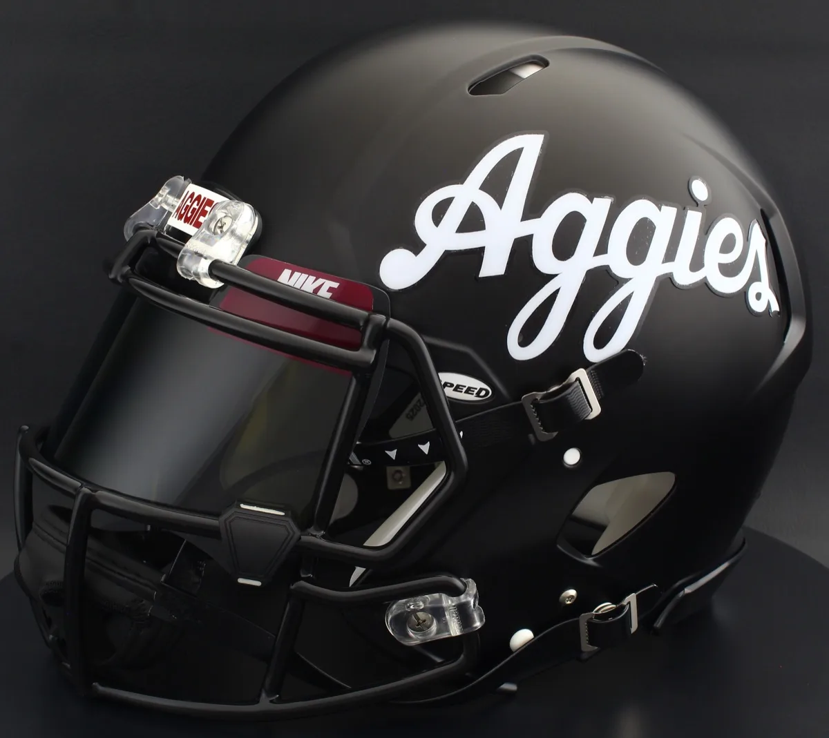 New Mexico State Aggies Riddell Replica Speed Football Helmet – Matte Black Script Aggies, Black Facemask, Black Visor, Maroon Brow Tabs, and Black Clips
