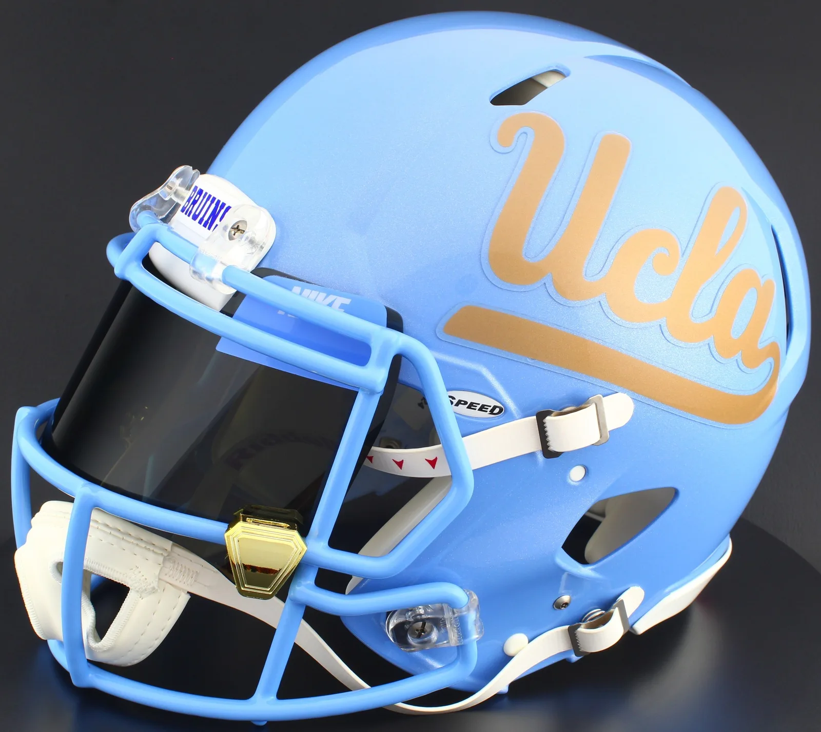 UCLA Bruins Riddell Replica Speed Football Helmet – Gold Script UCLA, Tar Heels Blue Mask, Nike Black Visor, Powder Blue Brow Tabs, and Gold Chrome Clips